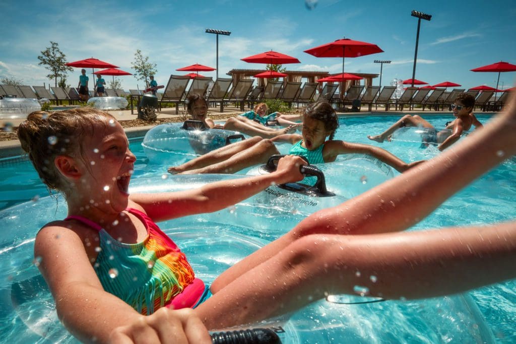 Several young children float down a lazy river in large tubes at Gaylord Rockies Resort & Convention Center.