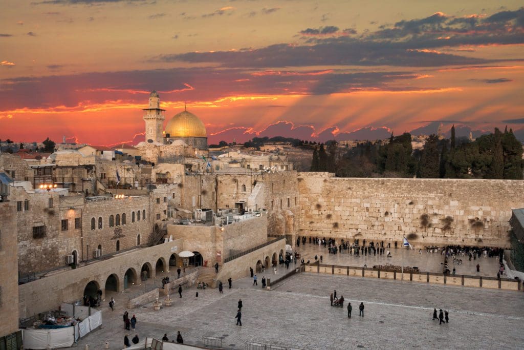 An aerial view of the Western Wall at the Dome Of The Rock on the Temple Mount in Jerusalem at sunset, one of the best places to visit during Easter with your family.