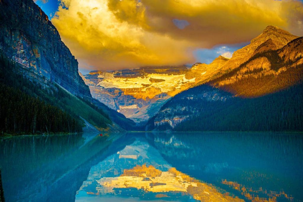 Sunrise at Lake Louise, featuring hues of blue, orange, and yellow.
