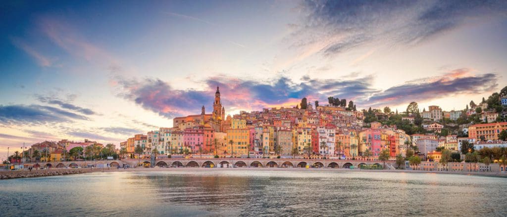 The colorful buildings of Menton flank the ocean in the French Riviera.