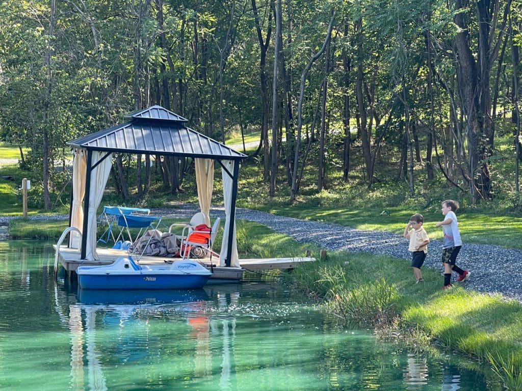 Two boys run toward a dock on a beautiful lake in Virginia.