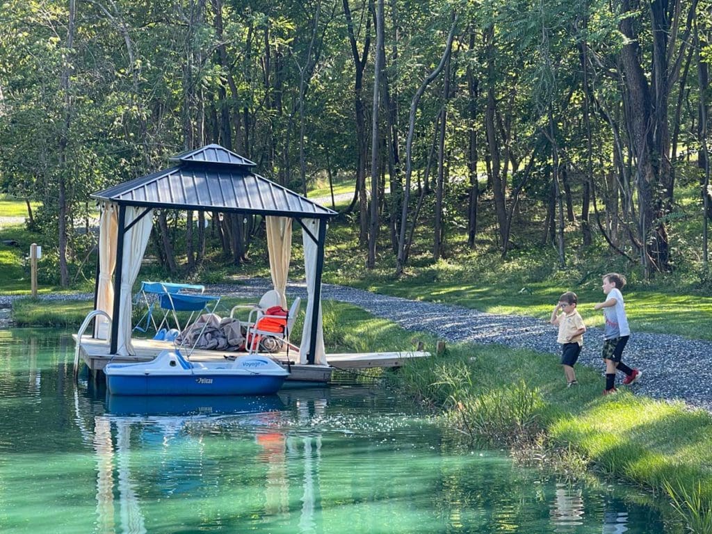 Two boys run toward a dock on a beautiful lake in Virginia. 