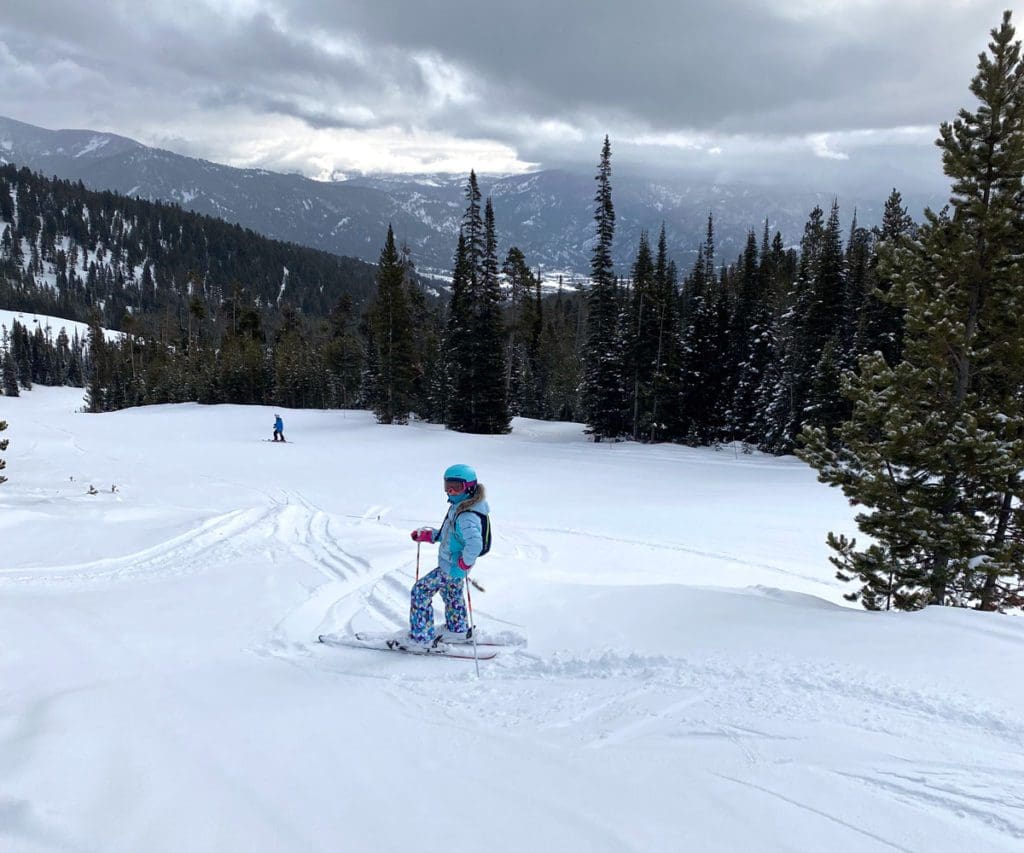 A young girl races down the slopes at Big Sky.