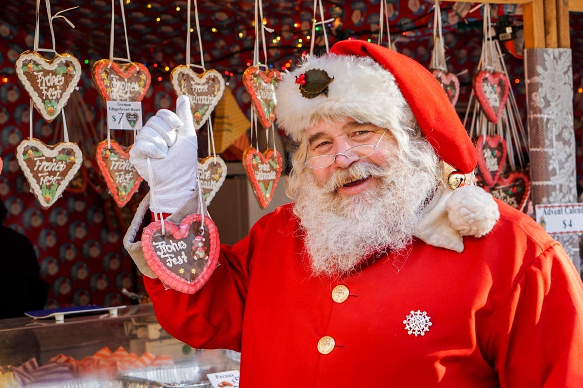 Santa holds up an ornament at Christmas Village.