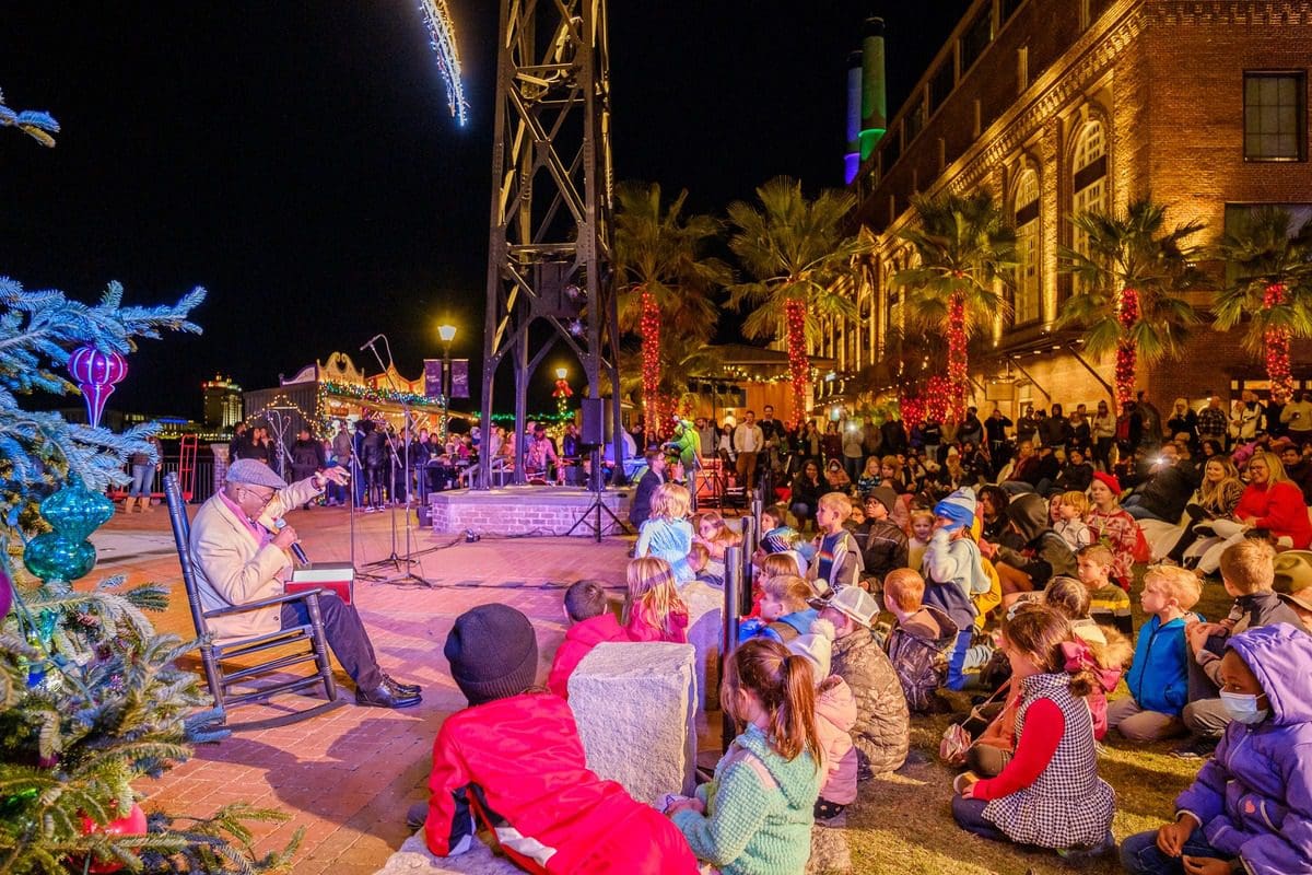 Kids listen to a story teller during the Christmas tree lighting at the Savannah Christmas Market.