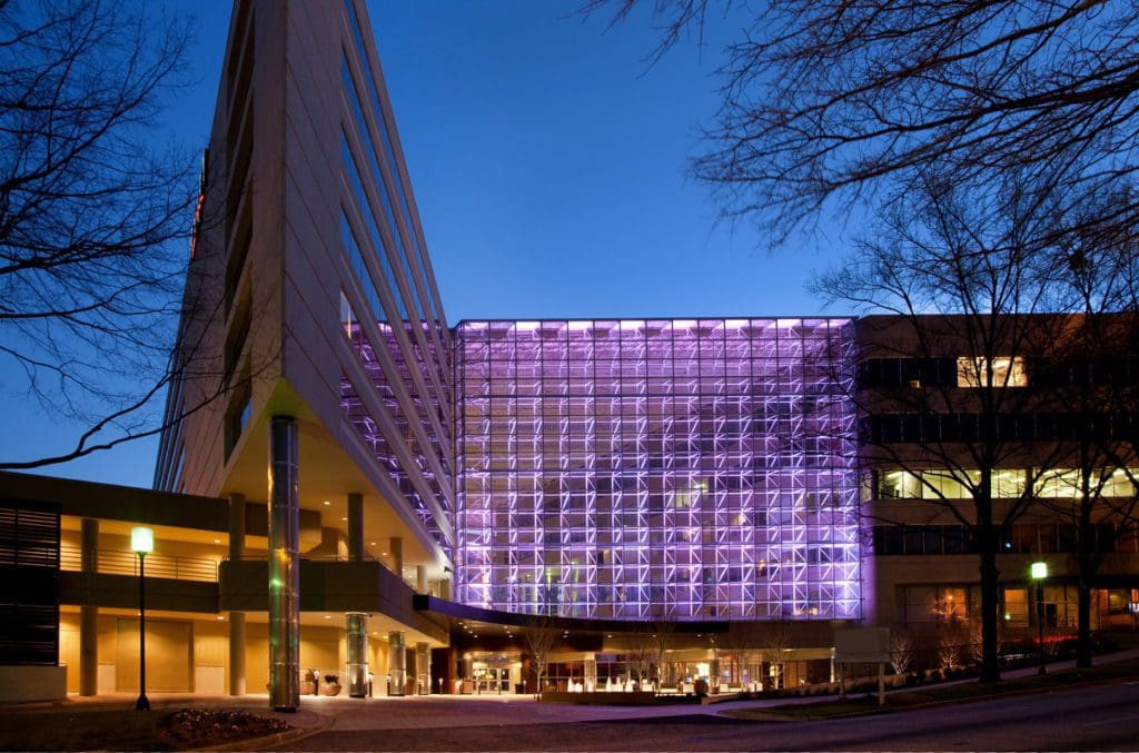 The exterior entrance to Hyatt Regency Greenville lit up at night.