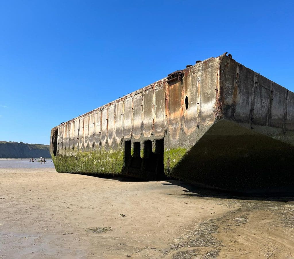 A large portion of a ship beached near Normandy in France.