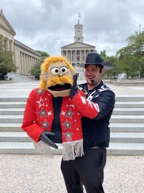 A tour guide with Puppet City Tours Nashville holds his puppet while on a tour of Nashville.