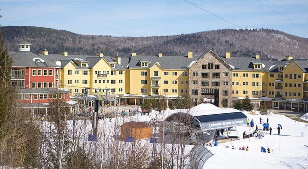 A view of Jackson Gore Village in the snow, one of the best places to stay while skiing at Okemo Mountain Resort.