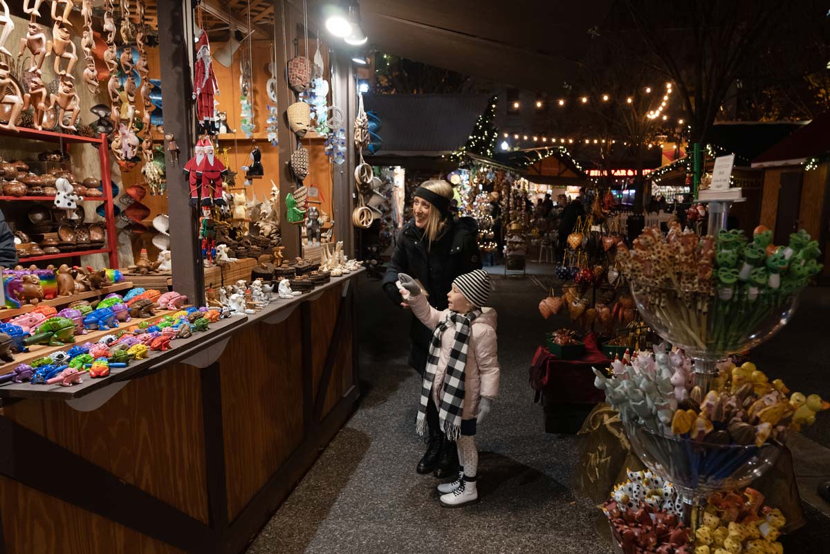 A little girl and her dad look at goods at a vendor at Peoples Gas Holiday Market.