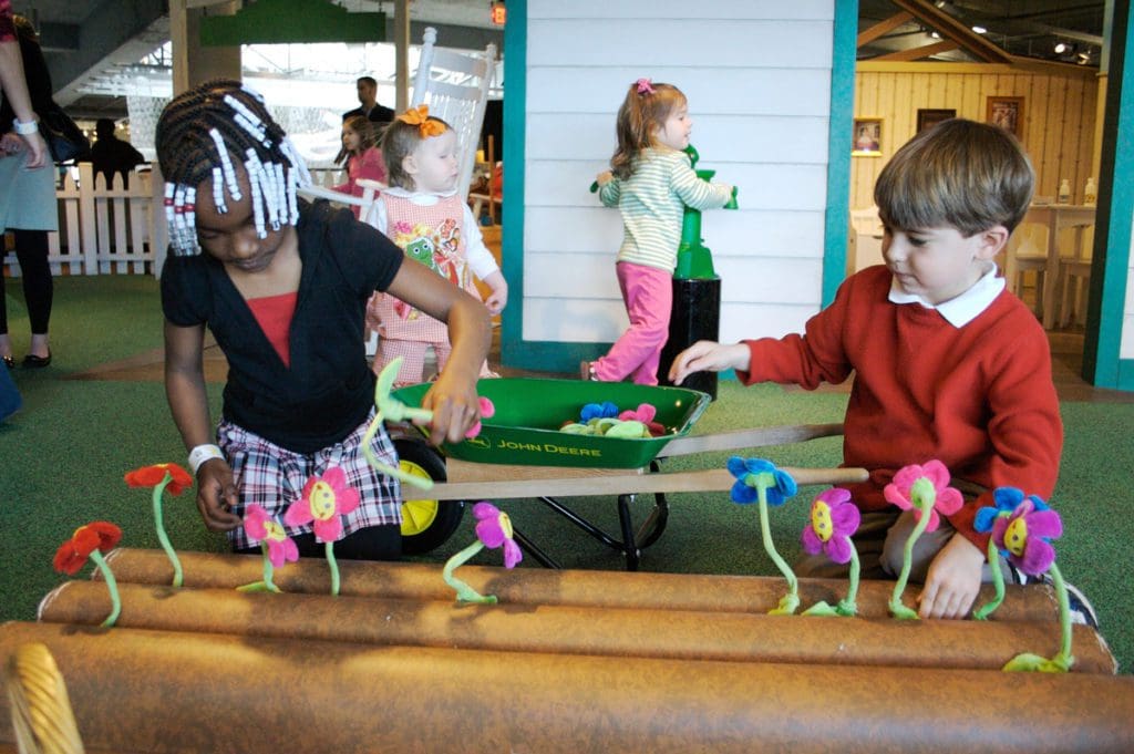Kids playing in a pretend garden exhibit at Children's Museum of the Upstate.