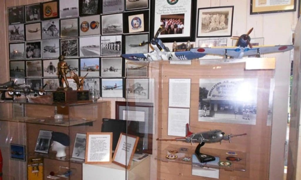 An exhibit at American Legion Military War Museum, featuring model planes and other war memorabilia.