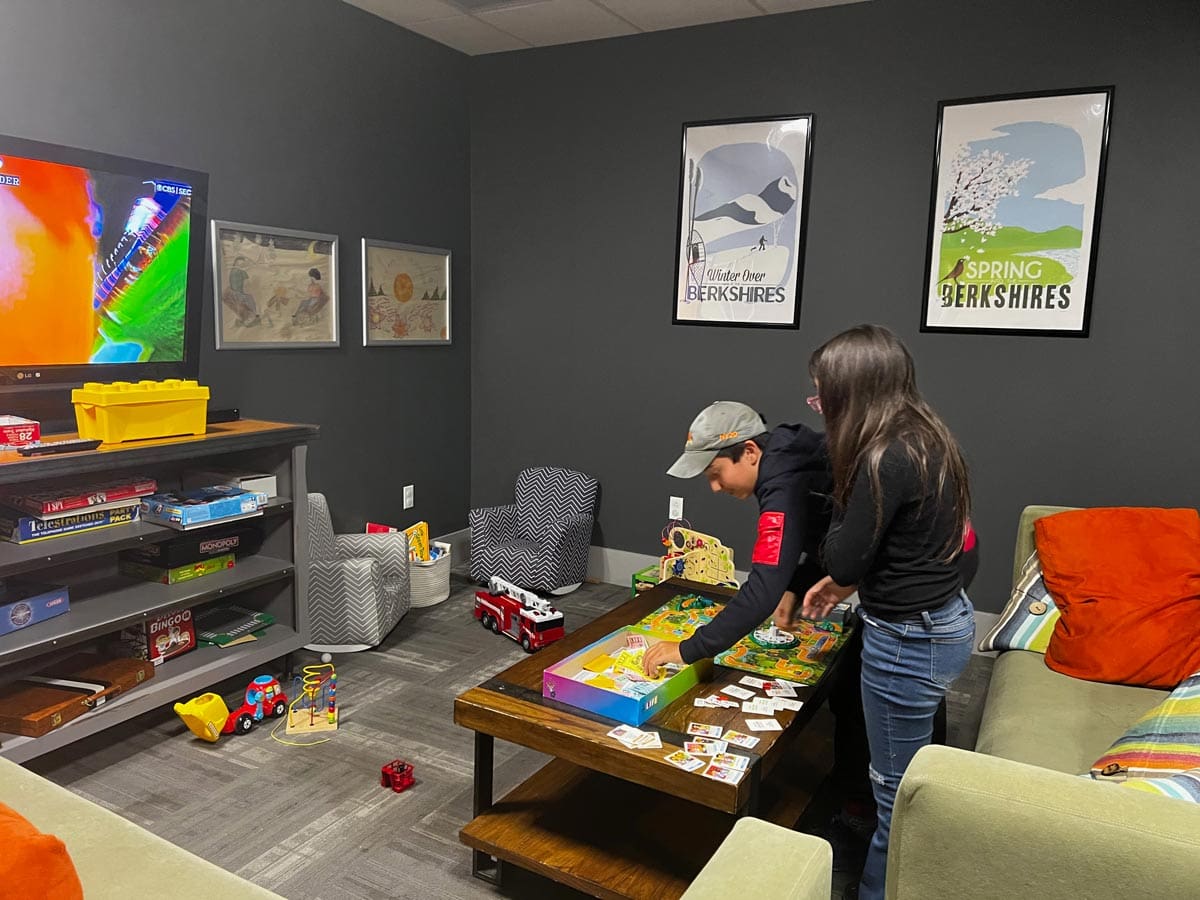 Two kids play in the on-site game room at Hotel on North in Pittsfield.