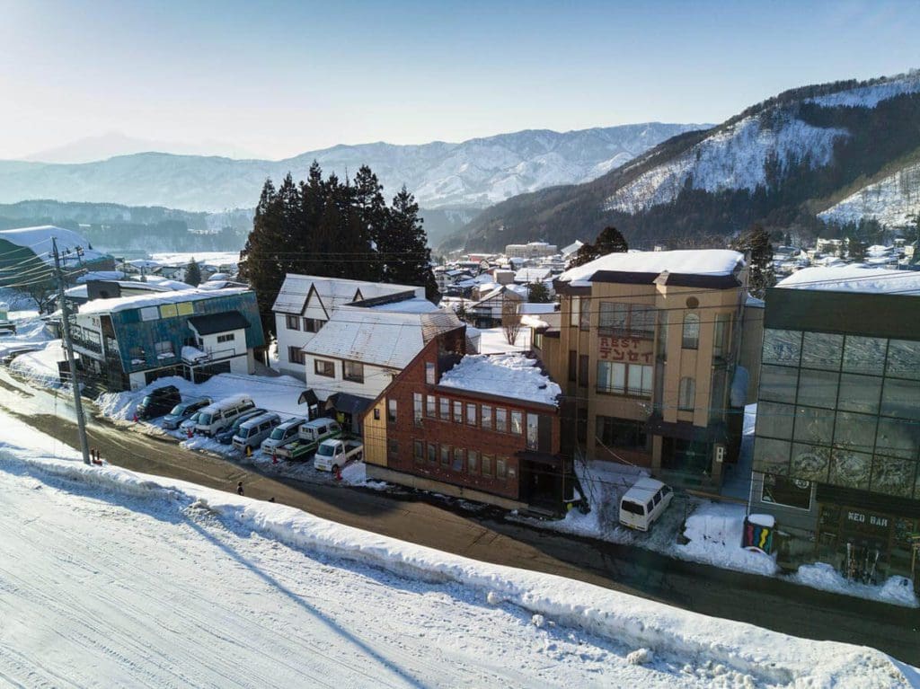 Accommodations along a snowy road near Nozawa Onsen Ski Resort.