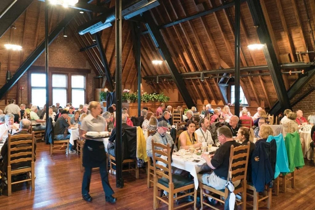 Families eating at large tables at the Stable Cafe on the grounds of the Biltmore Estate.