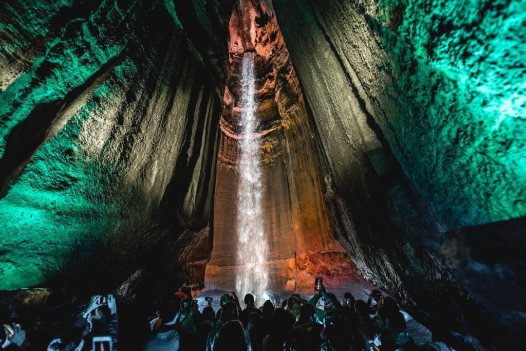 Several people look up at the large waterfall inside a cavern, Ruby Falls is one of the best things to do in Chattanooga with kids.