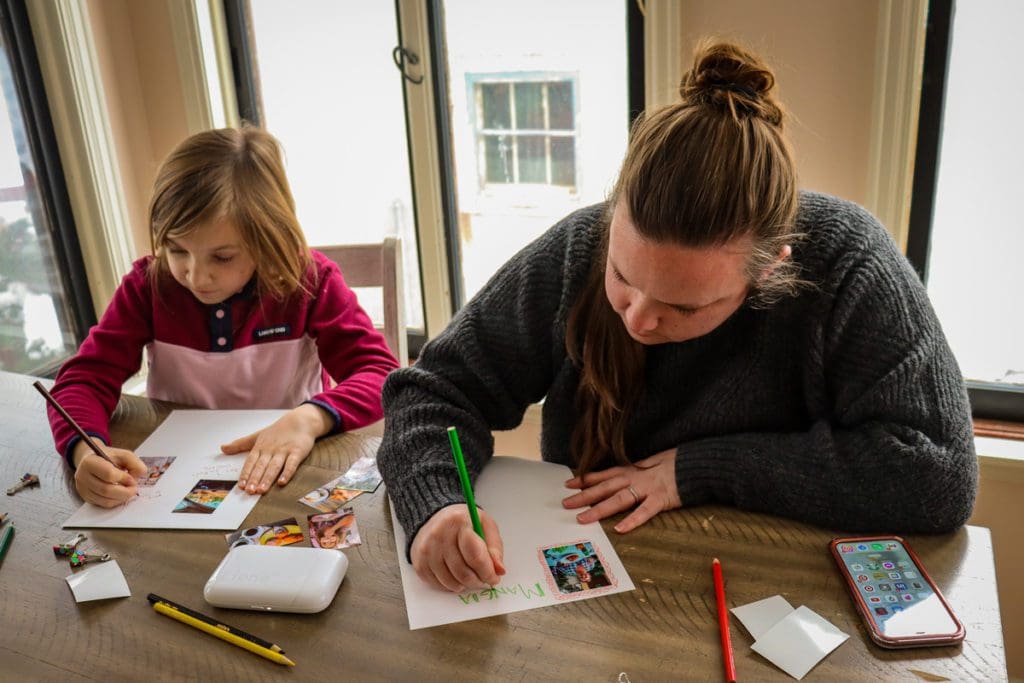 A mom and her young daughter create travel scrapbooks together using the Liene Pearl Portable Photo Printer.