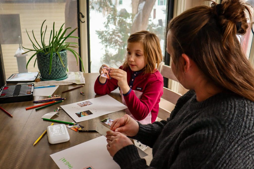 A mom and her young daughter use the Liene Pearl Portable Photo Printer to create travel diaries with pictures.