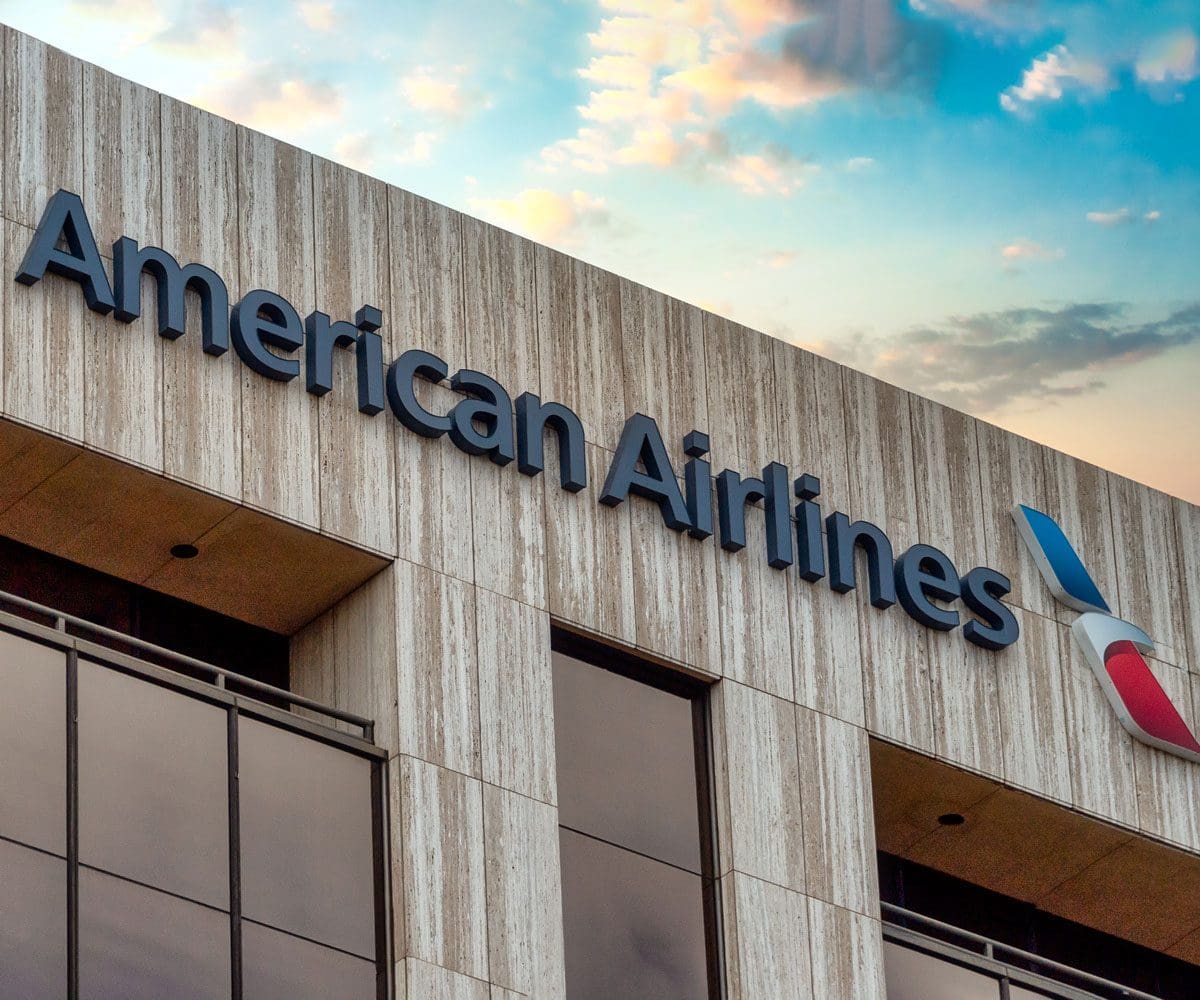 The American Airlines logo on a building, with blue skis above.