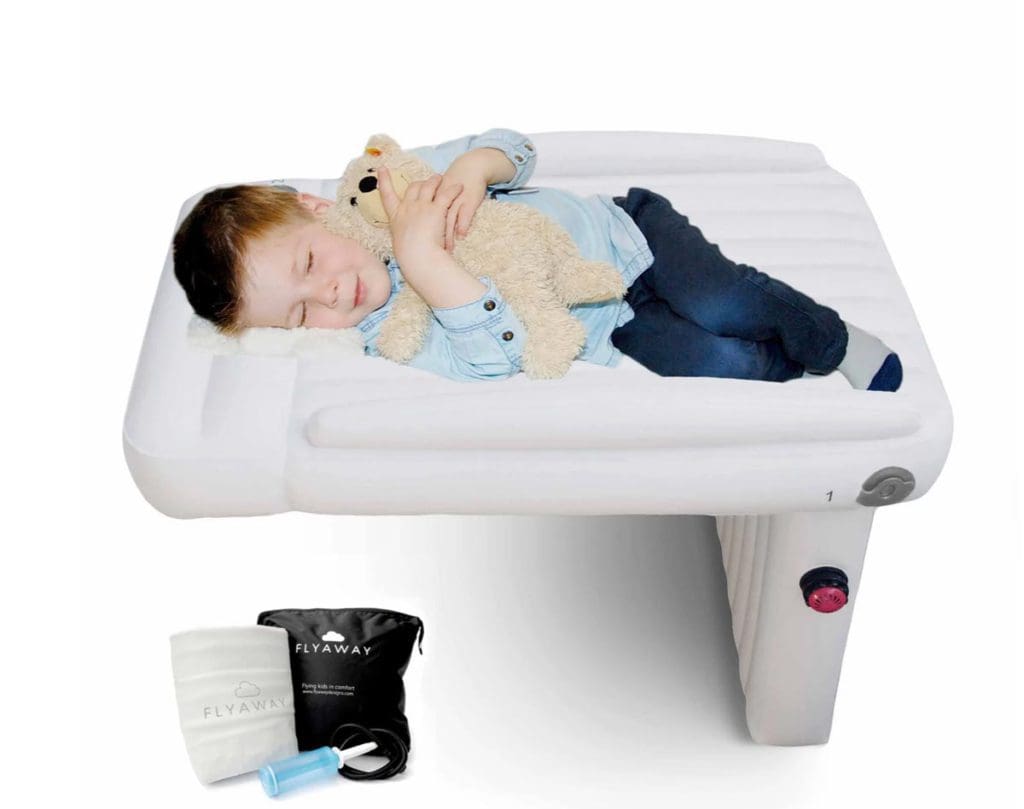 A product shot of a young boy sleeping with his teddy on a Flyaway Kids Bed.