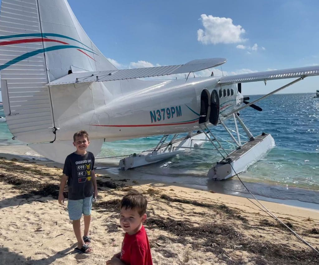 Two boys walk around a seaplane preparing to take them to Dry Tortugas National Park.