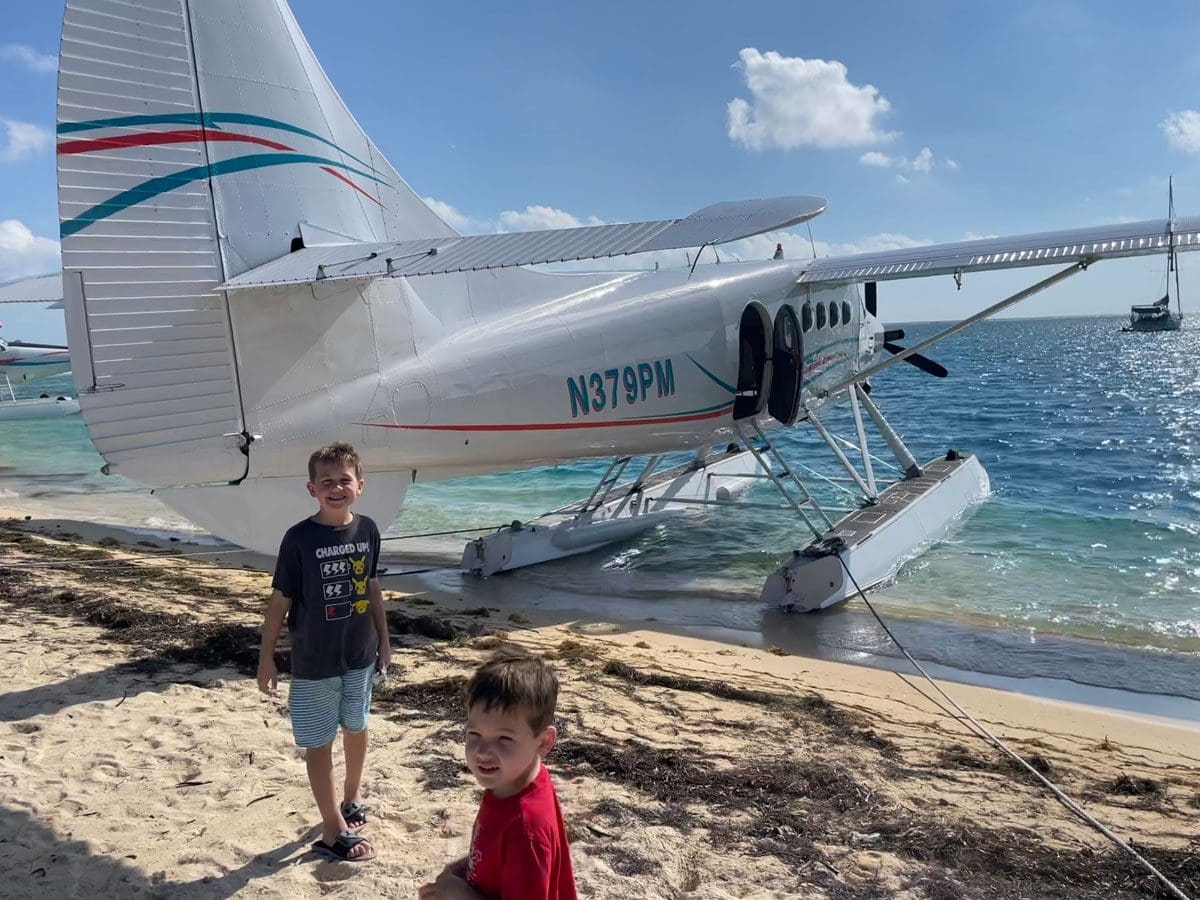 Two boys walk around a seaplane preparing to take them to Dry Tortugas National Park.