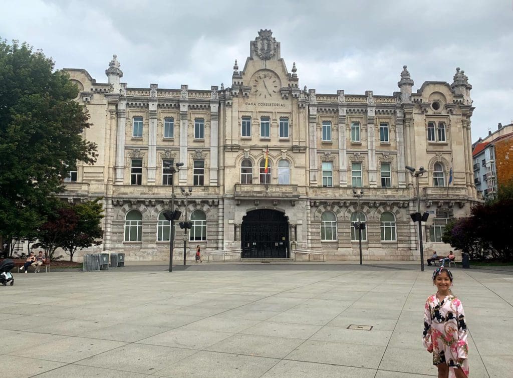 A young girl stands in Plaza Porticada in Santander, Spain.