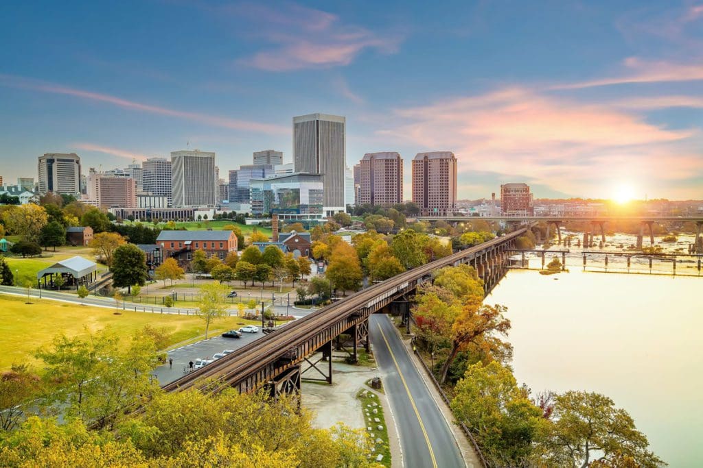 A lovely green space along the water, with the skyline of Richmond, Virginia in the distance.