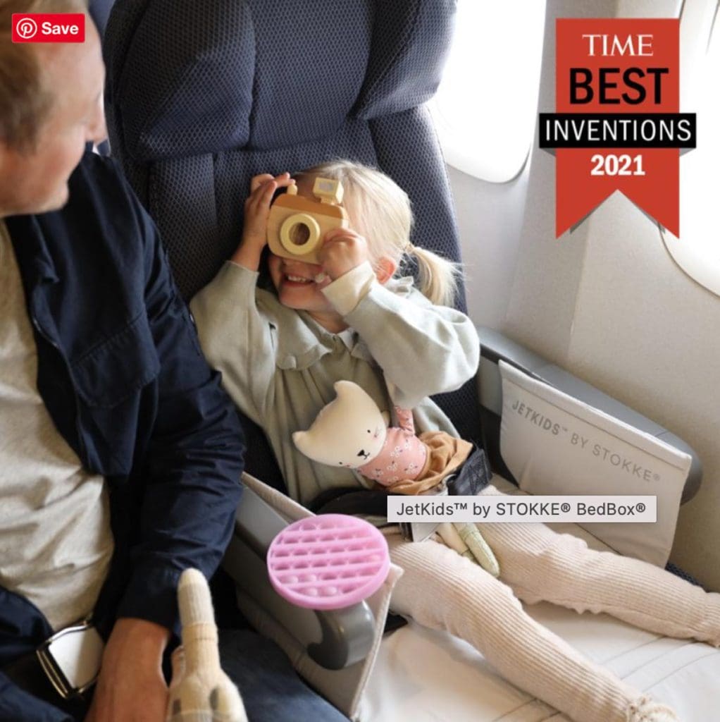 A little girl uses her Jetkids by Stokke Bedbox on a long flight.