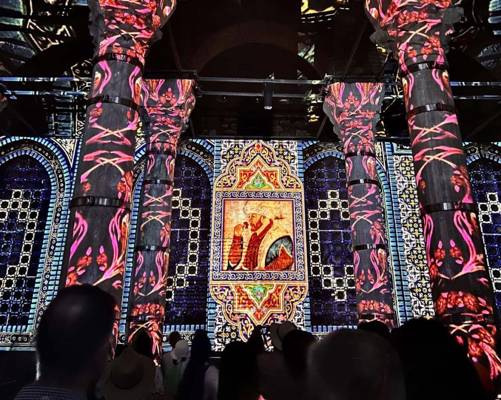 A crowd of people enjoy a light show at the Basilica Cisterns in Istanbul, a great activity on a Turkey itinerary for families.