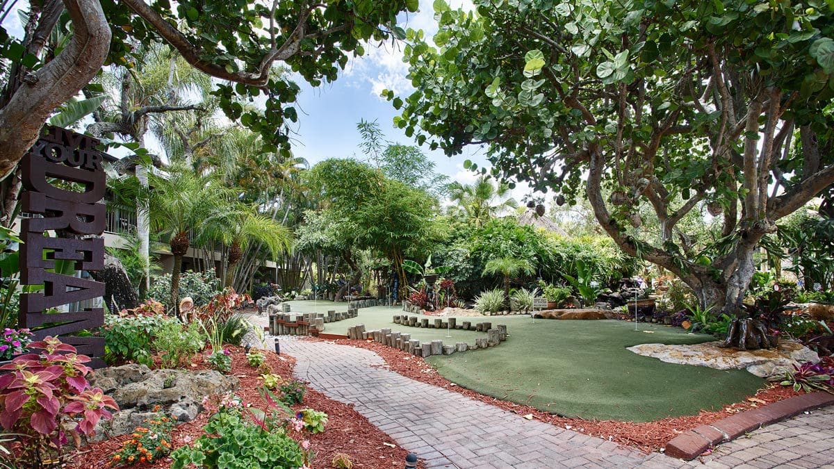 The lush grounds and entrance to Best Western Naples Inn & Suites, one of the best hotels in Naples for families.