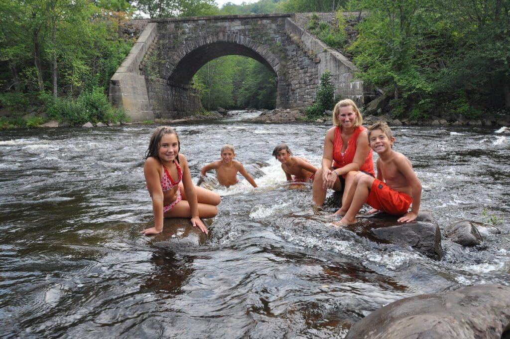 A mom and her four kids swim in the Lehigh River in the Pocono Mountains.