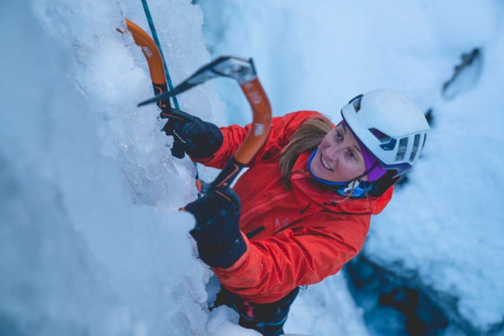 A woman smiles as she ice climbs near Chamonix, France.