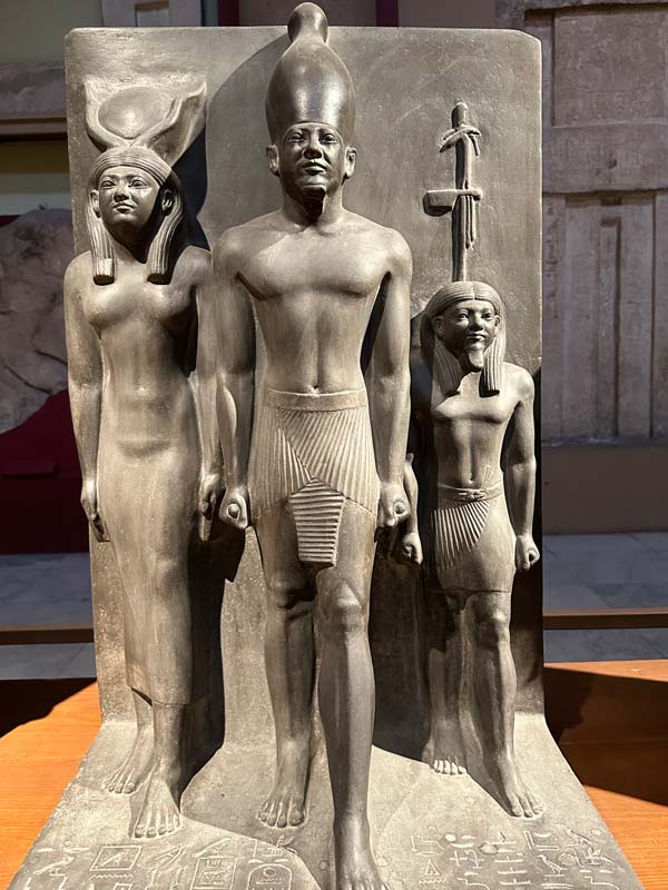 An exhibit showing an Egyptian statue of a Pharaoh and his family at the Egyptian Museum.