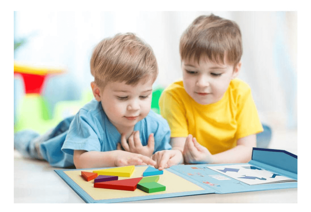 Two boys lay on the floor and play with a BEESTECH Wooden Tangram Puzzle Book, one of the best travel toys for young kids.