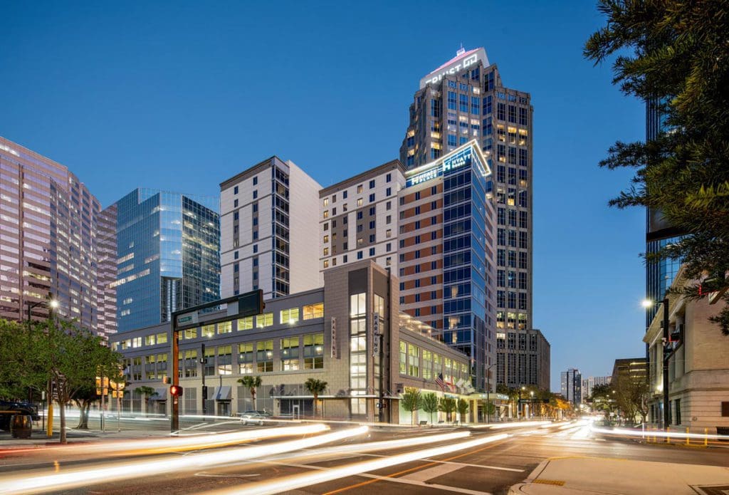 The exterior of Hyatt Place Tampa Downtown lit up at night.