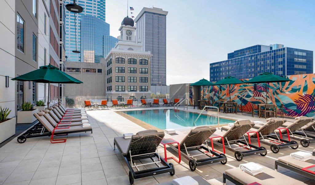 The vibrantly colored and styled rooftop pool at Hyatt Place Tampa Downtown, one of the best hotels in Tampa Bay for families.