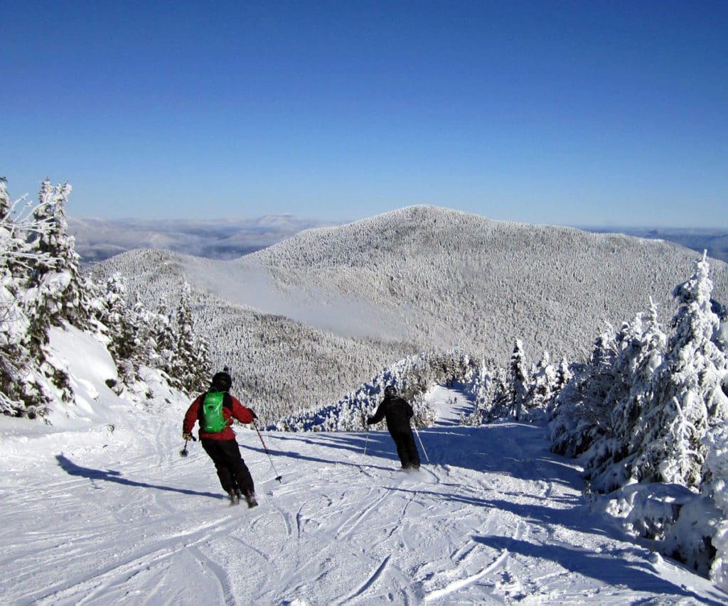 Two people ski down the slopes at Smugglers' Notch Mountain in Vermont.