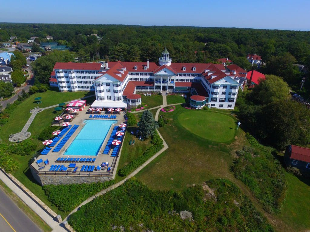 An aerial view of the buildings and grounds of he buildings and grounds of The Colony Hotel, one of the best Maine hotels for families.