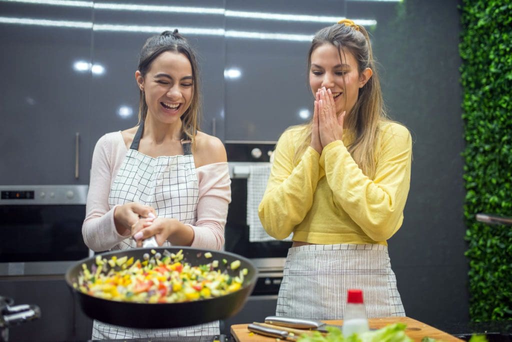 Mom and daughter cook together at a cooking class.