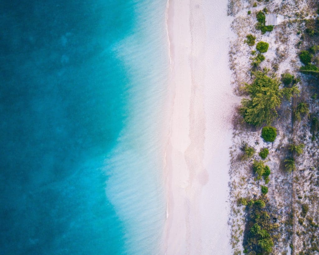 An aerial view of Grace Bay Beach, with pristine white sands and blue waters.