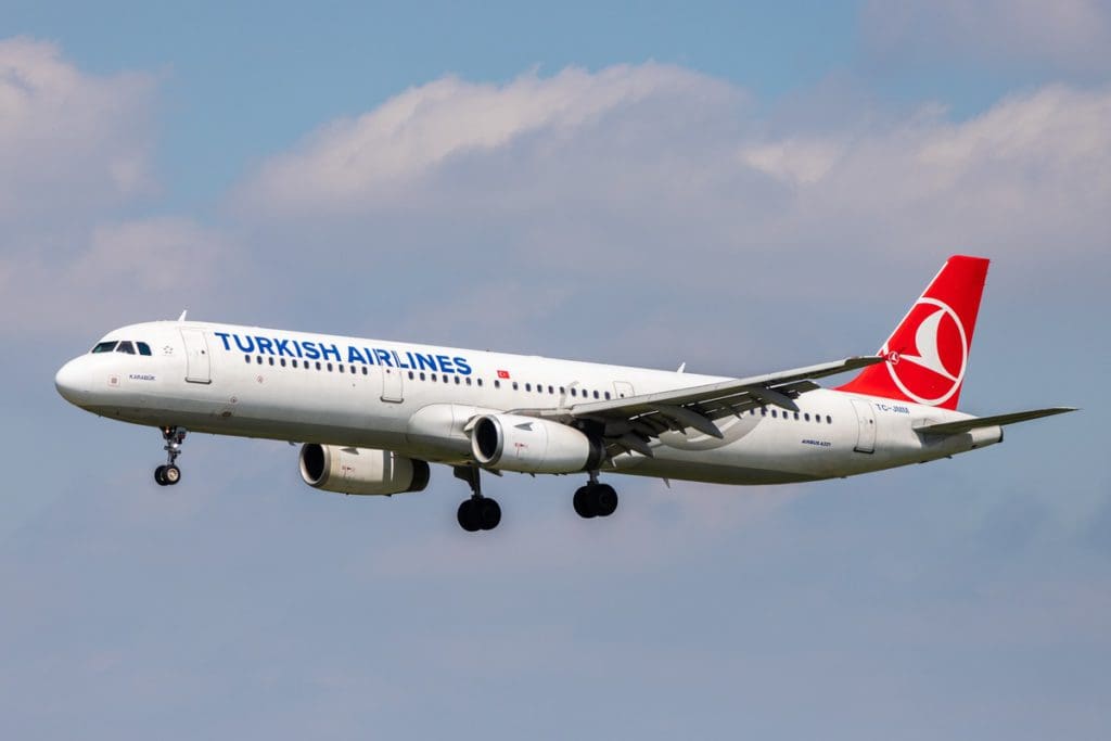 A Turkish Airlines plane flying high amongst the clouds, one of the best airlines for kids.