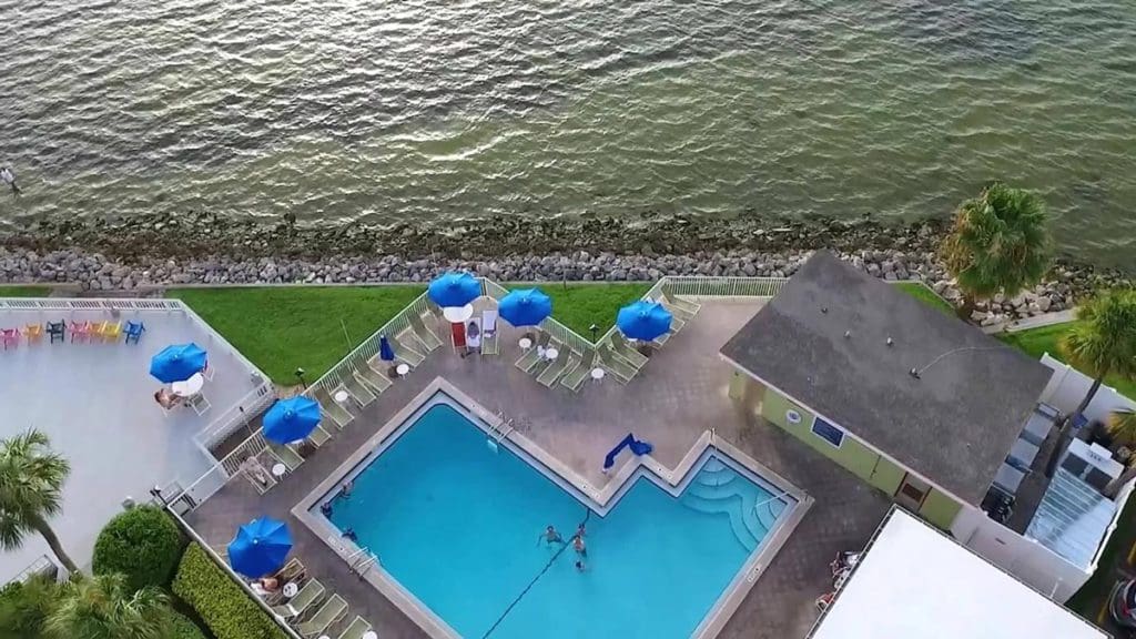 An aerial view of the waterfront pool area at Sailport Waterfront Suites.