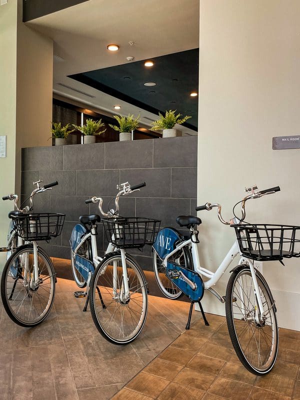 Three bikes rest in the lobby of AVE Tampa Riverwalk, awaiting families.