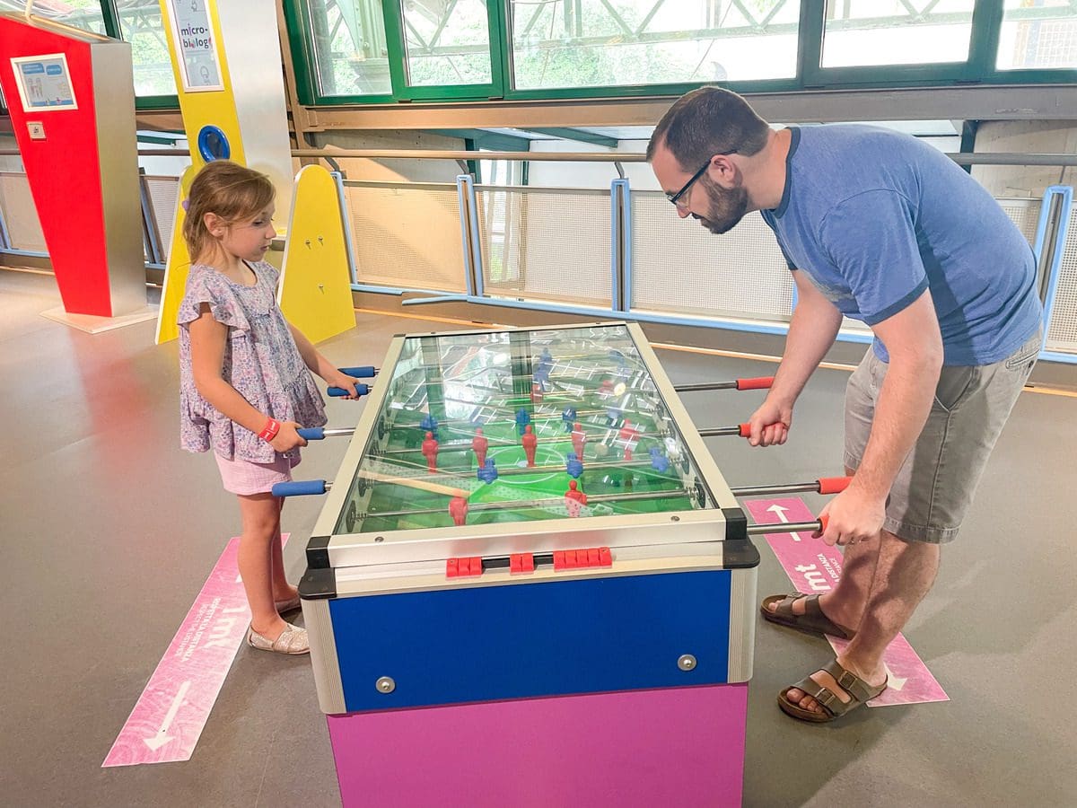 A dad and his young daughter play at a game table at Explora il Museo dei Bambini di Roma.