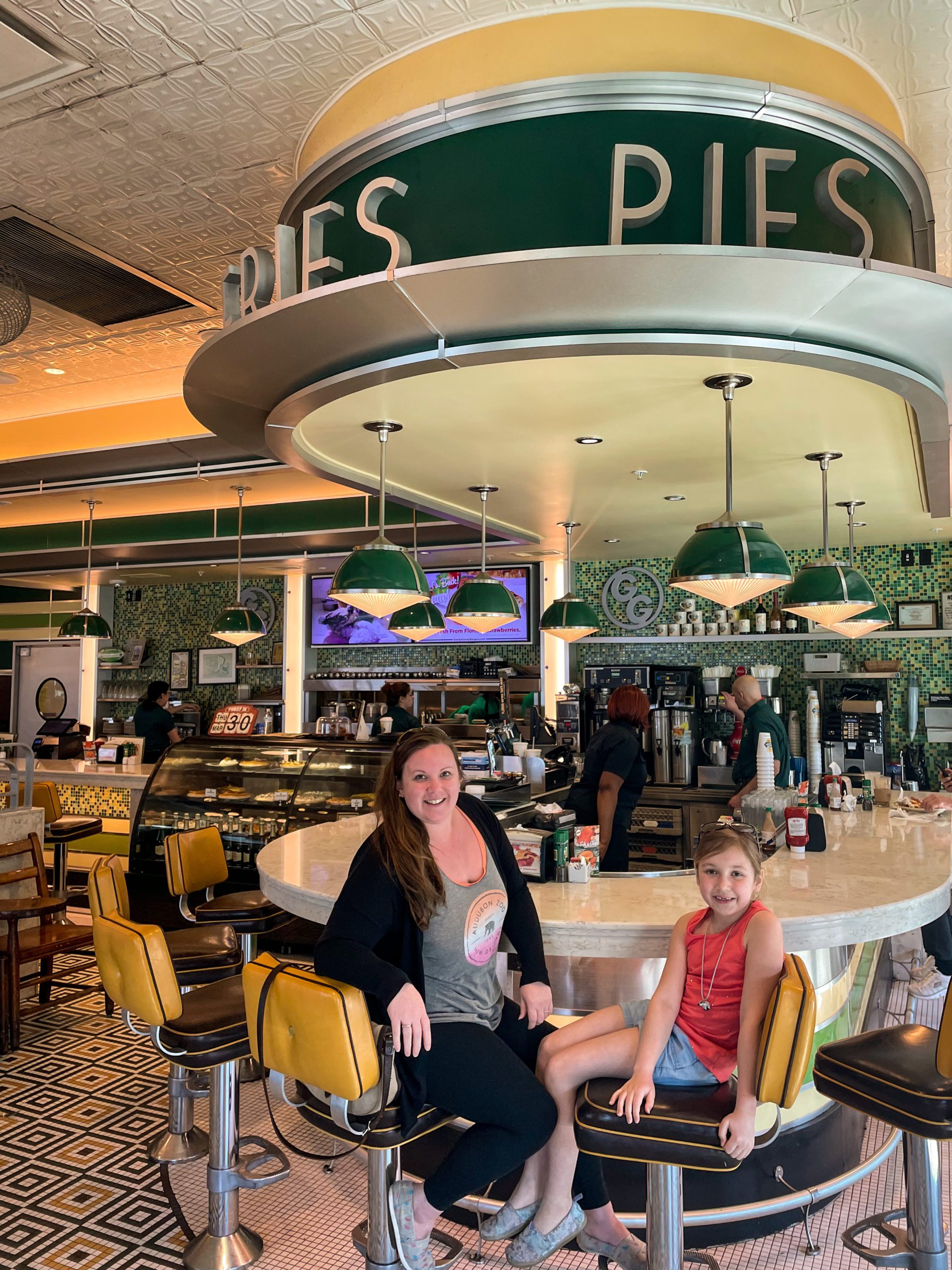 A woman and her daughter sit at the diner counter of Goody Goody Burgers.