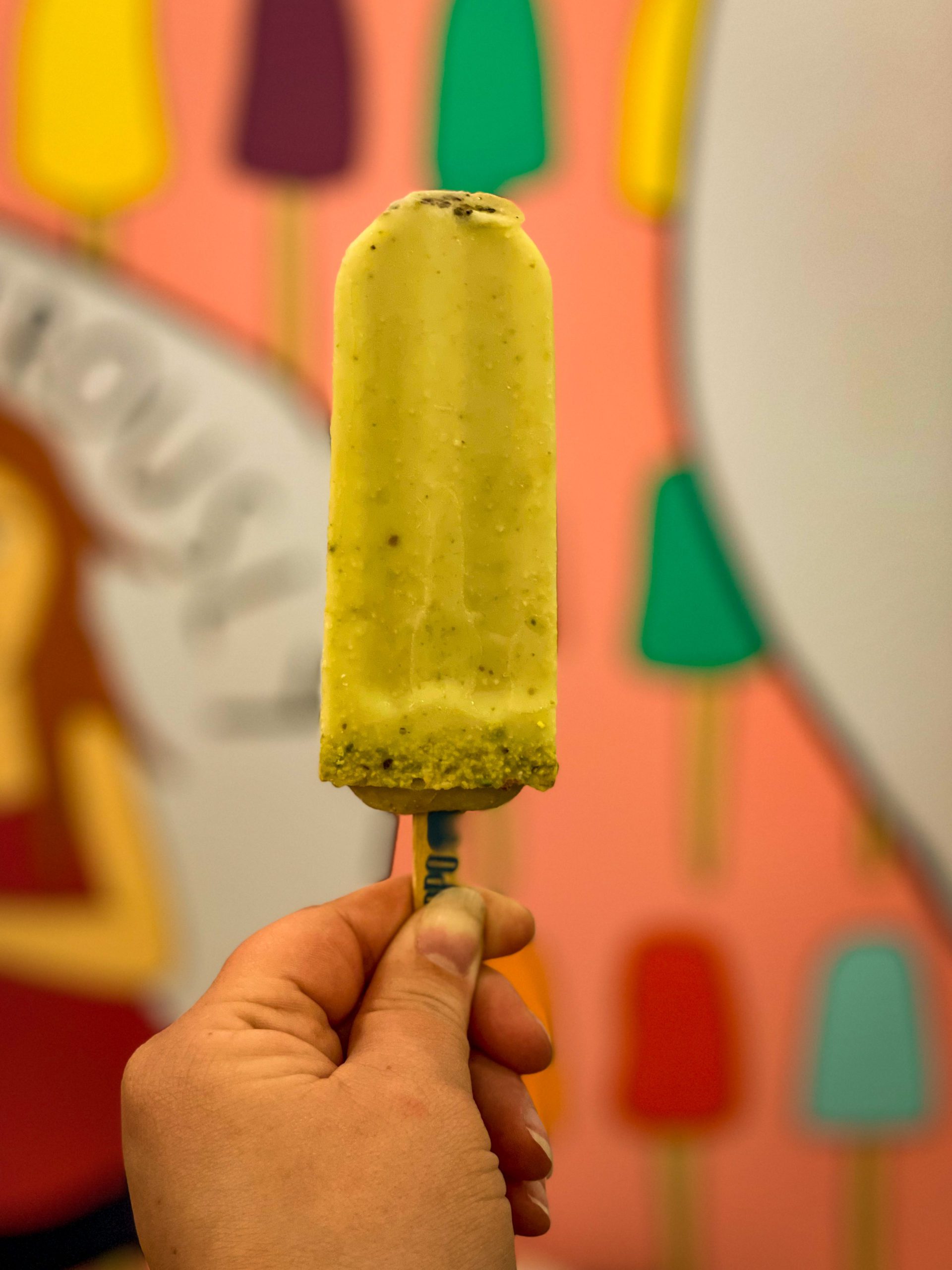 A hand holds up a coconut and avocado Popsicle at The Hyppo in the Hyde Park neighborhood of Tampa Bay.