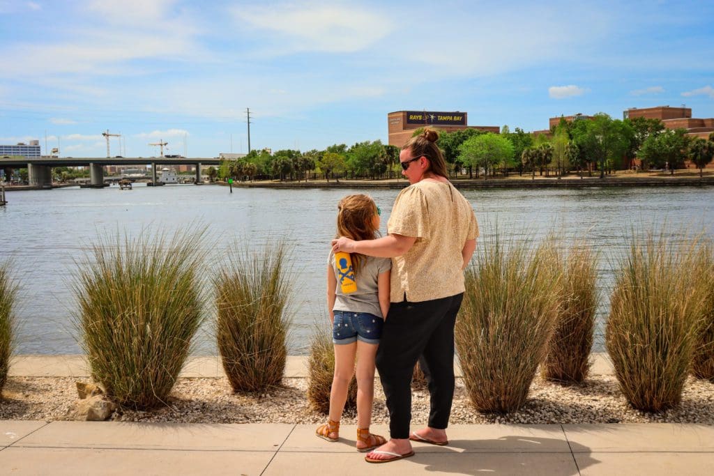 A young girl and her mom look out onto the Hillsborough River, while exploring Tampa Bay.