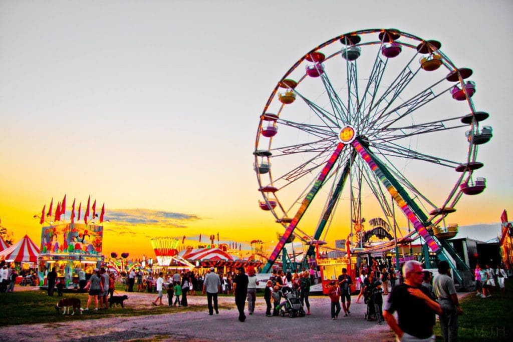 A Ferris Wheel and other carnival features at Asbury Park Summer Kickoff Carnival at sunset in Ashbury Park, one of the best places to visit during Memorial Day Weekend near NYC for families.