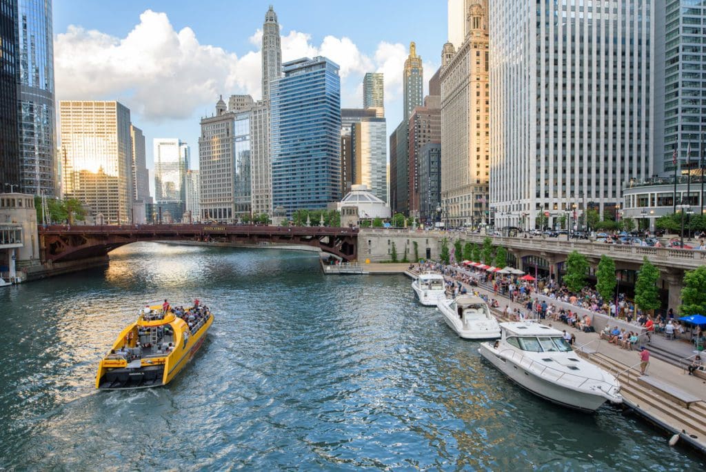 A Chicago Riverboat Architecture Tour boat takes passengers down the river on a tour in Chicago, one of the best places to travel with your mom.